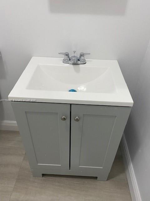 bathroom featuring baseboards and vanity