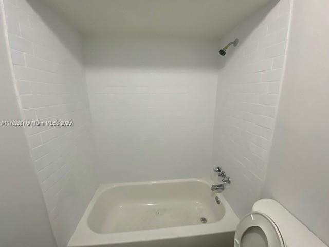 bathroom with toilet and shower / washtub combination