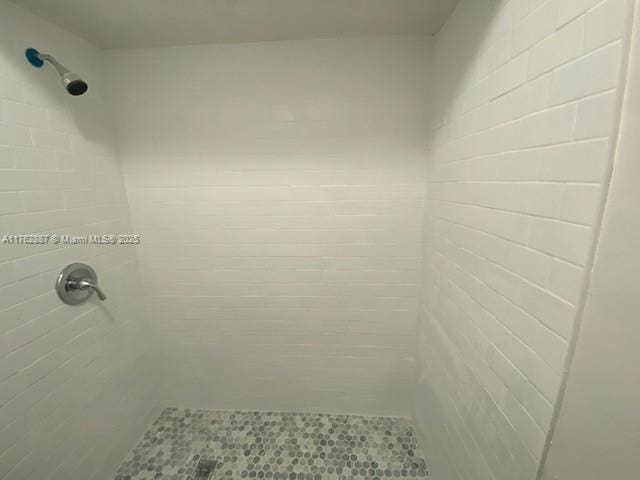 full bath with a shower stall