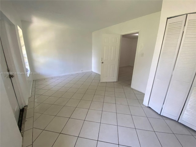 interior space with light tile patterned floors and a closet