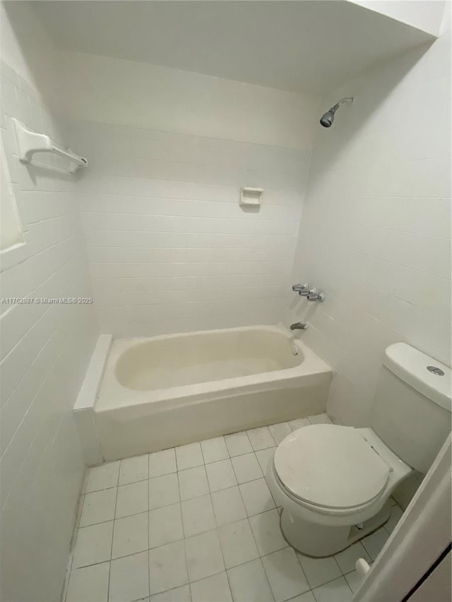 full bath featuring tile patterned flooring, tile walls, toilet, and shower / bathtub combination