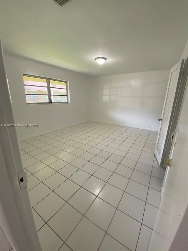 spare room with light tile patterned floors