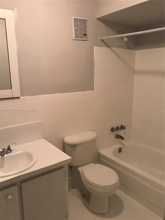 full bath with vanity, visible vents, tub / shower combination, tile walls, and toilet