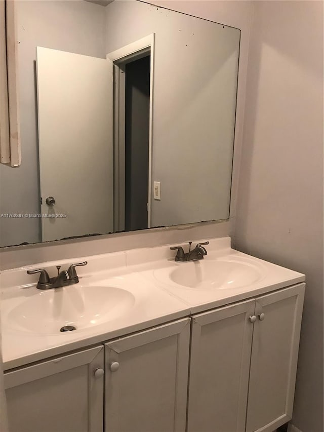 bathroom with a sink and double vanity