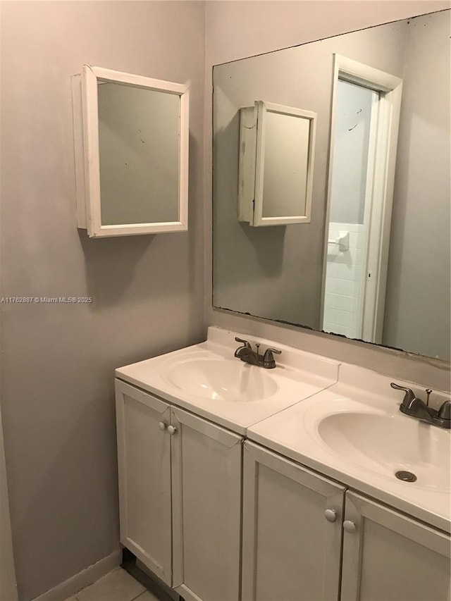 bathroom featuring a sink and double vanity