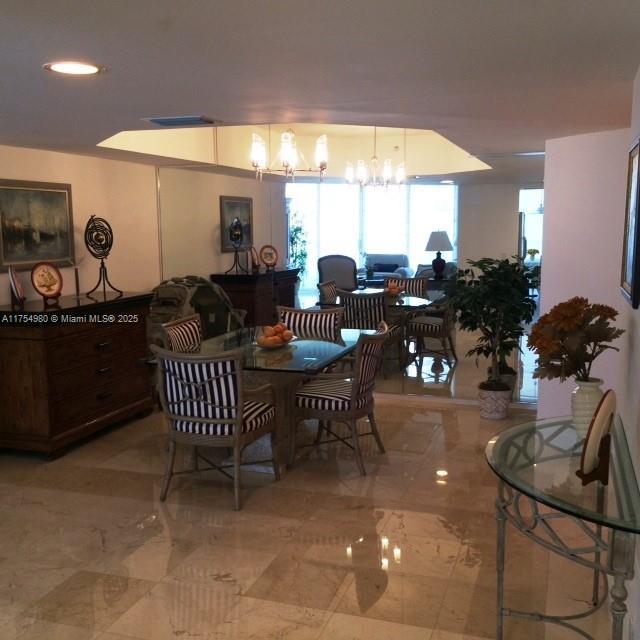 dining area featuring an inviting chandelier and visible vents