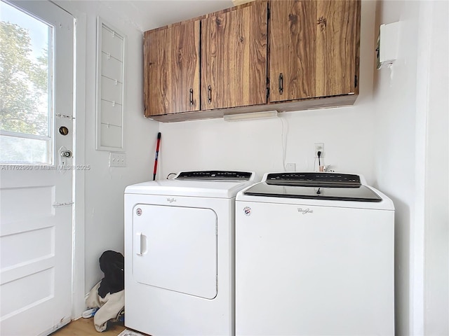 laundry room with washing machine and dryer and cabinet space