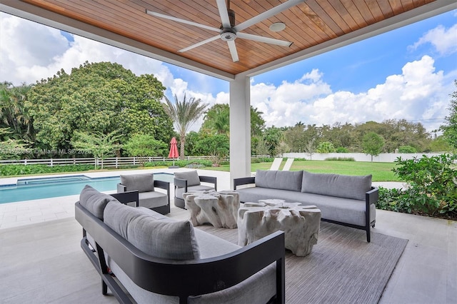 view of patio with a ceiling fan, a fenced backyard, a fenced in pool, and an outdoor hangout area