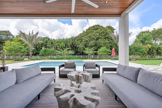 view of patio featuring a deck, a fenced in pool, fence, and an outdoor hangout area