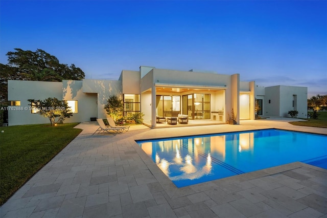 pool featuring a yard and a patio