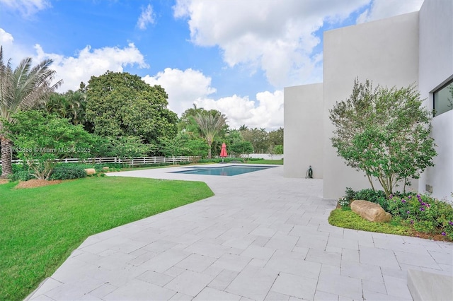 view of pool featuring a fenced in pool, a lawn, a patio, and fence