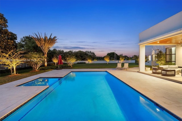 outdoor pool with outdoor lounge area and a patio