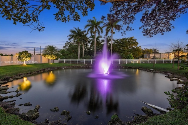 surrounding community featuring a water view and fence