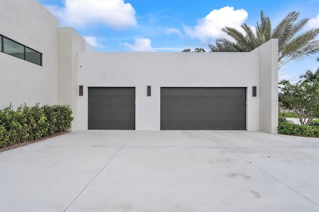 garage featuring concrete driveway