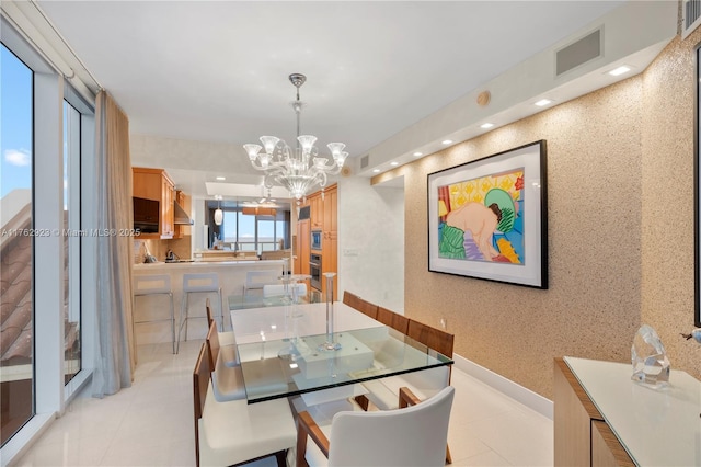 dining area with light tile patterned floors, visible vents, wallpapered walls, an inviting chandelier, and recessed lighting