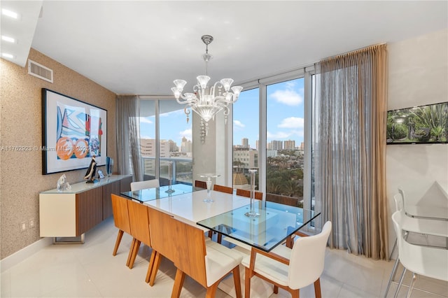 dining room featuring visible vents, wallpapered walls, a city view, floor to ceiling windows, and a notable chandelier