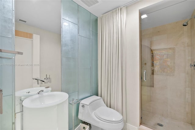 full bath with visible vents, a shower stall, and toilet