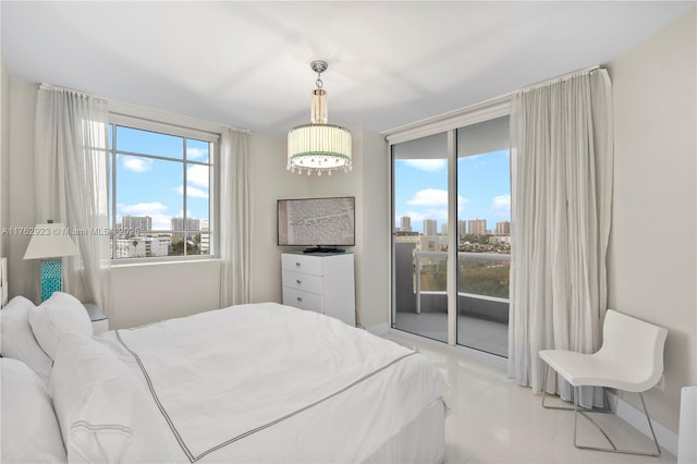 bedroom featuring a city view, access to exterior, and a wall of windows