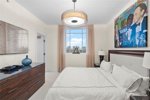 bedroom featuring baseboards and light tile patterned flooring