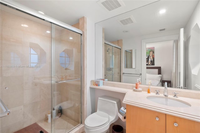 ensuite bathroom with vanity, toilet, visible vents, and connected bathroom