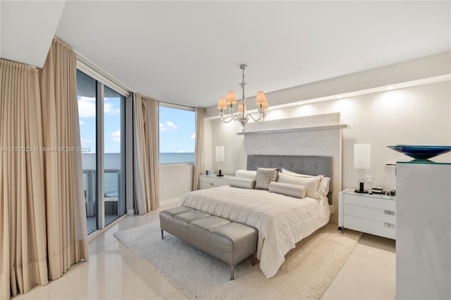 bedroom featuring light tile patterned floors, expansive windows, a notable chandelier, and access to outside