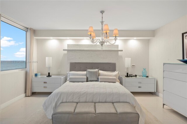 bedroom with tile patterned floors, a fireplace, baseboards, and a chandelier