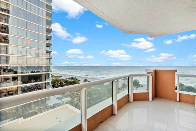 balcony with a view of the beach and a water view