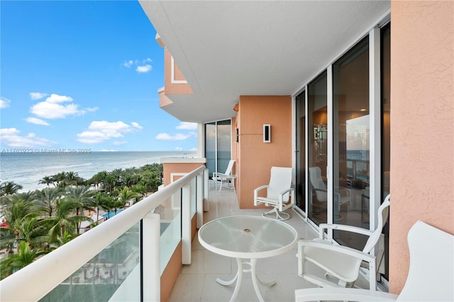 balcony with a beach view and a water view