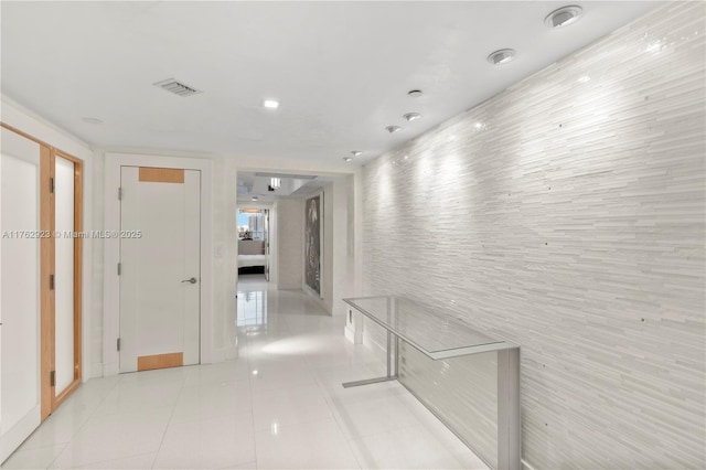 corridor with light tile patterned flooring and visible vents