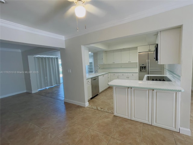 kitchen featuring a sink, appliances with stainless steel finishes, a peninsula, crown molding, and light countertops