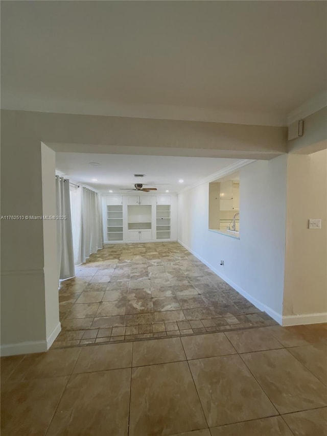 tiled spare room with built in features, baseboards, ceiling fan, and crown molding