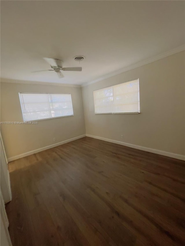 unfurnished room with ceiling fan, crown molding, baseboards, and wood finished floors