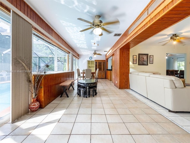 interior space with a wealth of natural light, visible vents, and a ceiling fan