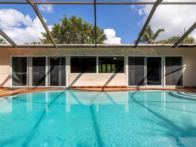 outdoor pool featuring glass enclosure