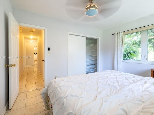 bedroom with ceiling fan, a closet, and light tile patterned flooring