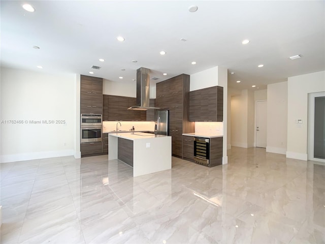 kitchen with visible vents, light countertops, appliances with stainless steel finishes, island range hood, and modern cabinets