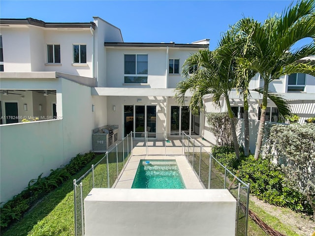 back of house with a patio area, stucco siding, a fenced backyard, and a fenced in pool