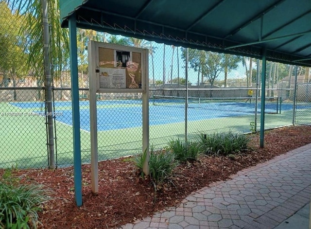 view of tennis court with fence