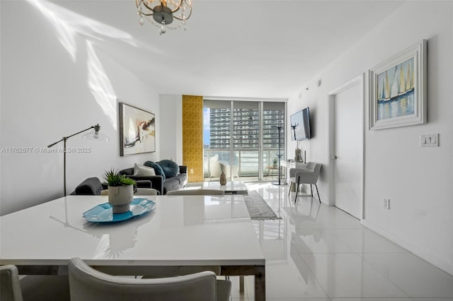 dining room featuring an inviting chandelier, a wall of windows, and light tile patterned floors