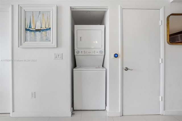 washroom with stacked washer / drying machine and laundry area