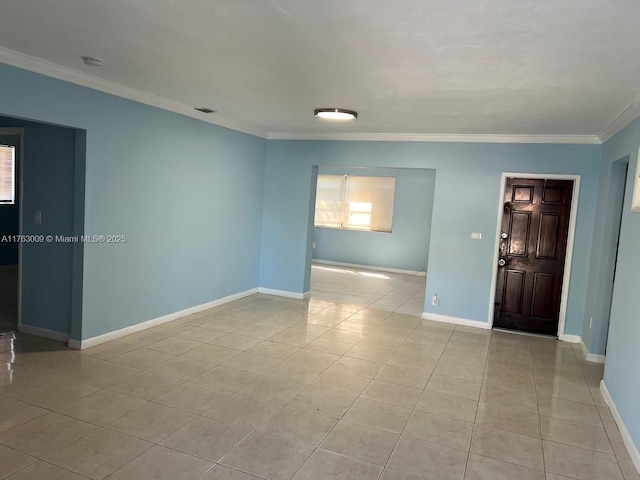 unfurnished room with crown molding, light tile patterned flooring, and baseboards