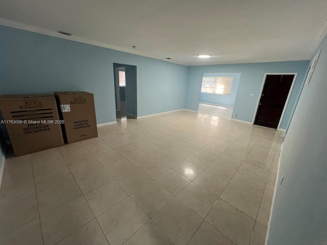 empty room with light tile patterned floors, visible vents, and baseboards