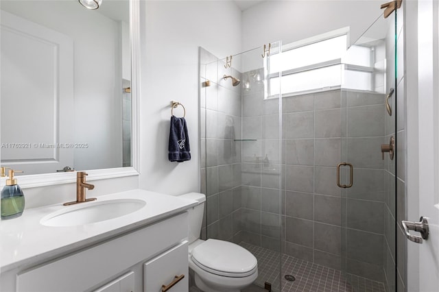 full bath featuring a stall shower, toilet, and vanity