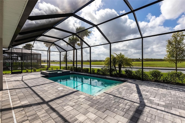 view of swimming pool featuring a patio, a pool with connected hot tub, and a lanai