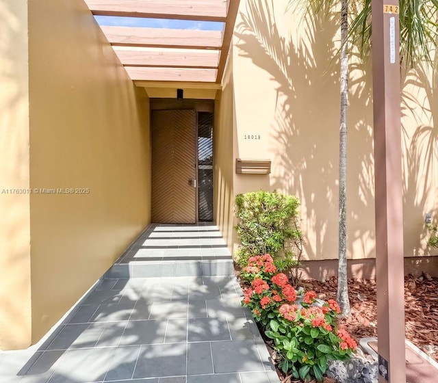 property entrance with stucco siding