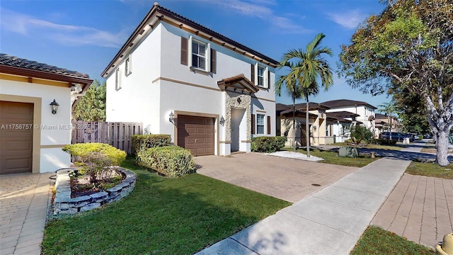 view of front of home featuring a tiled roof, decorative driveway, an attached garage, and stucco siding