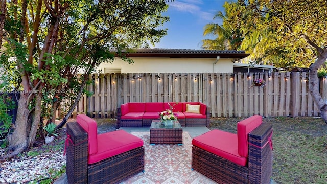 view of patio with an outdoor living space and fence