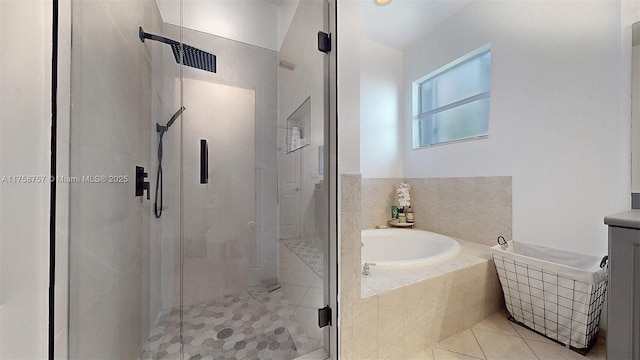 bathroom with tile patterned floors, a garden tub, a stall shower, and vanity