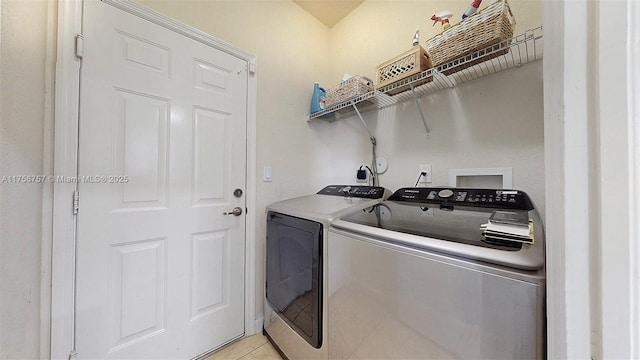 laundry room with laundry area, light tile patterned flooring, and separate washer and dryer