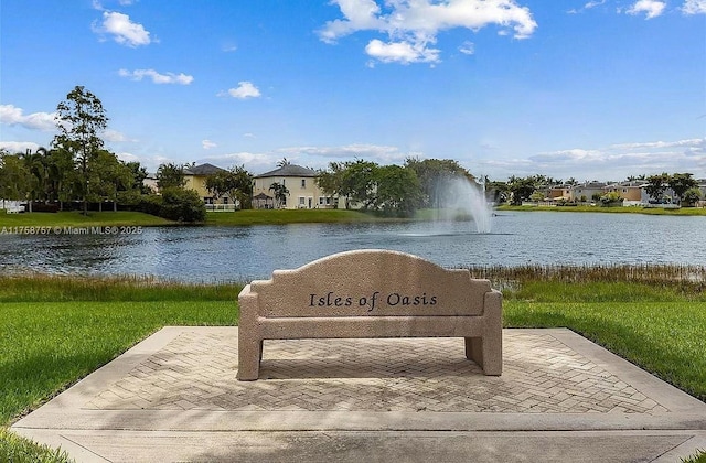 view of community featuring a lawn and a water view